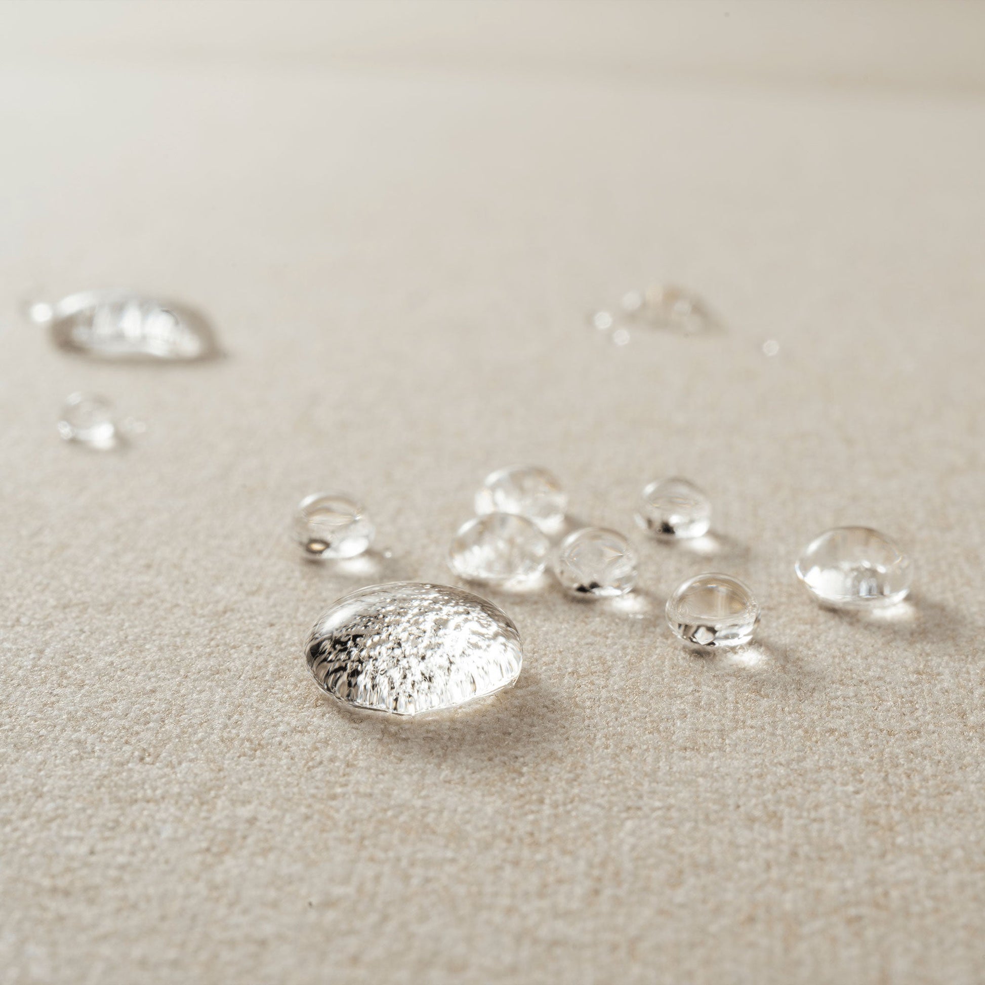  A close-up of water droplets on Rezy Sofa's sophisticated stain-resistant fabric